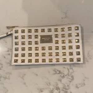 Michael Kors white clutch with gold studs.
